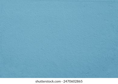 The surface of a rough wall painted with blue paint. Blue plaster close-up. - Powered by Shutterstock