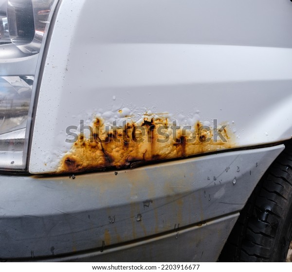 Surface Rust\
On The Bodywork Of A White Van Or\
Truck