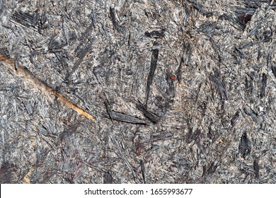 The Surface Of A Sheet Of Old Worn Waferboard Which Has Red Splotches Of Paint In Places Exterior Wall.