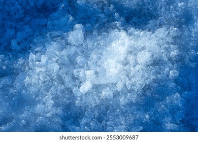 A surface of small snow and ice chips on blue background. Display for product