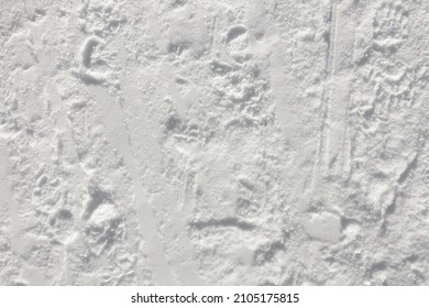 The Surface Of The Snow, Compact And Flat But With Grooves And Footprints. Textured Material, Overhead Closeup Shot.
