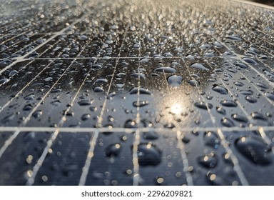 surface of a solar panel with sun reflection ans rain drops - Powered by Shutterstock - Get 15% off with code: PIKWIZARD15