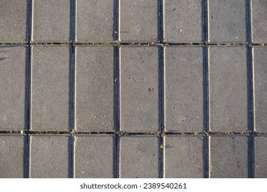 Surface of stack bond brick like gray concrete pavement