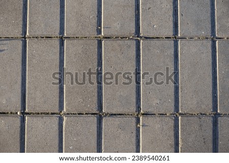 Surface of stack bond brick like gray concrete pavement