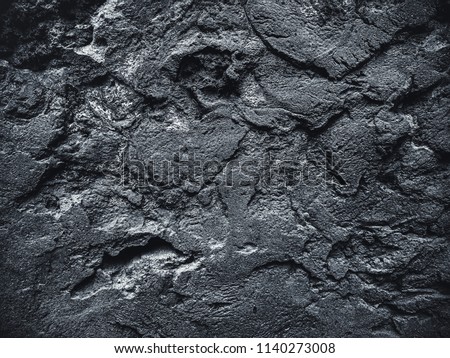 Surface of an stone wall. Black Stone background. Rock texture. Rock pile background.