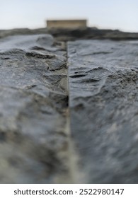the surface texture of the black and gray stone with the central focus rising upwards.
