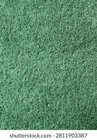 The surface texture of a scrub sponge after being used once.