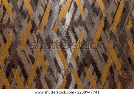 The surface of the textured wallpaper with a grey-brown graphic pettern. Modern trends in decor and interior design. Close-up.