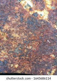 Surface Of The Thick Steel Plate That Is Rusty Brown- Red Color.  It Begins To Weather In Little By Little