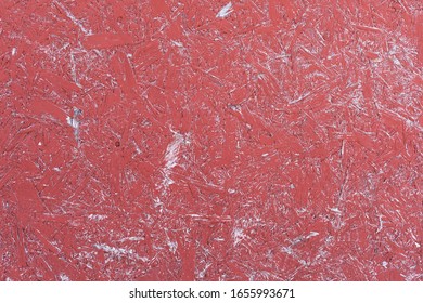 The Surface Of Waferboard Which Has Been Painted Red That Has Faded Over Time.