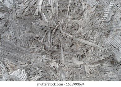 The Surface Of Waferboard Which Has Faded Over Time To A Whitish Gray.