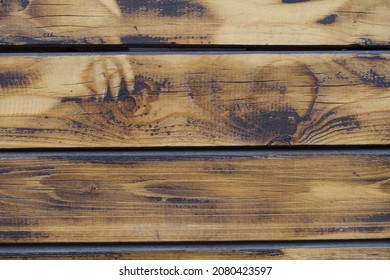 Surface of wall made of burnt and brushed wooden planks