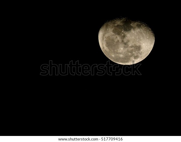 surface of waning gibbous moon on a black sky,view\
from earth