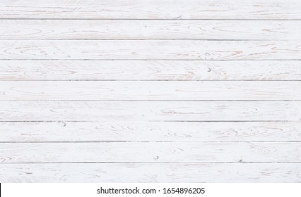 A surface of white worn out wooden boards in horizontal position. for vintage backgrounds, wedding invitations or spring motives