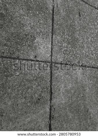 The surfaces are diverse, including rough cement floors, smooth plastered floors, painted walls, and walls that have been dampened by rainwater and are covered in moss.