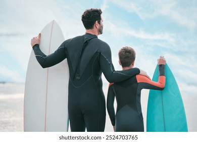 Surfboard, dad and child on beach for back view, sports or exercise on outdoor bonding adventure. Surfer, father and son at ocean for surfing, teaching and learning together with support and growth - Powered by Shutterstock