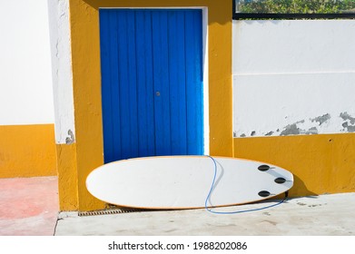 Surfboard Leaning Against Old Building Wall