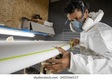 Surfboard manufacturing, Shaper working on board details. Concept of industrial manufacturing, qualified professional, occupation and employment. - Powered by Shutterstock