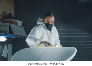 Surfboard manufacturing, Shaper working on board details. Concept of industrial manufacturing, qualified professional, occupation and employment. - Powered by Shutterstock