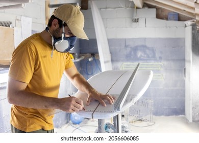 Surfboard Modeling Workshop - Man perfecting the modeling of a surfboard - Powered by Shutterstock