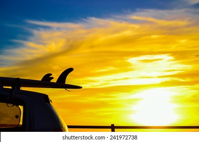 Surfboard On A Car Roof At Sunset. Shot In Sardinia, Italy