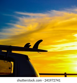 Surfboard On A Car Roof At Sunset. Shot In Sardinia, Italy