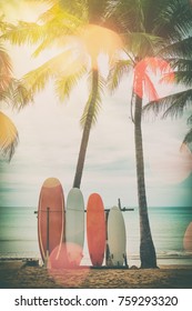 Surfboard And Palm Tree On Beach Double Exposure With Colorful Bokeh Sun Light Texture Abstract Background. Summer Vacation And Sport Extreme Concept. Vintage Tone Filter Color Style.