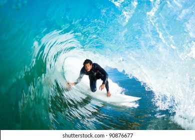 Surfer In The Barrel On Amazing Blue Ocean Wave