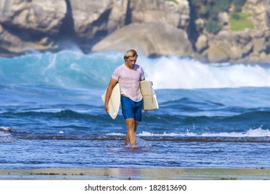 Surfer With Broken Surfboard