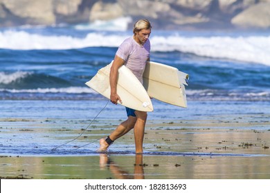 Surfer With Broken Surfboard