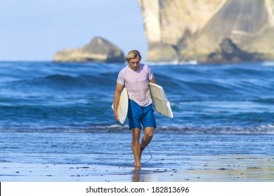 Surfer With Broken Surfboard