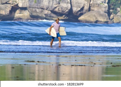 Surfer With Broken Surfboard