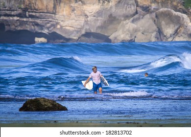 Surfer With Broken Surfboard