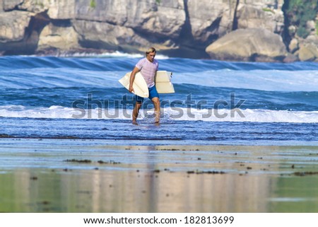 surfer with broken surfboard