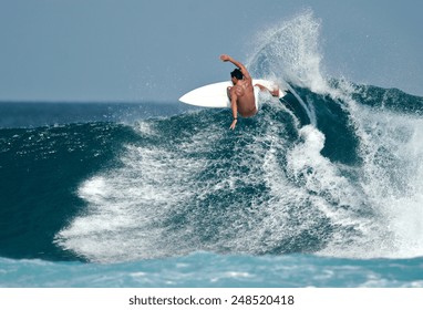A surfer carves a radical off-the-lip.
