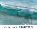 Surfer catching a barrel at Manly Beach, Sydney. This photo captures the thrill of riding a perfect wave, highlighting the action and beauty of surfing at this iconic Australian beach.