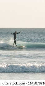 Surfer Catching Small Wave On Longboard At Wedge Island, Western Australia