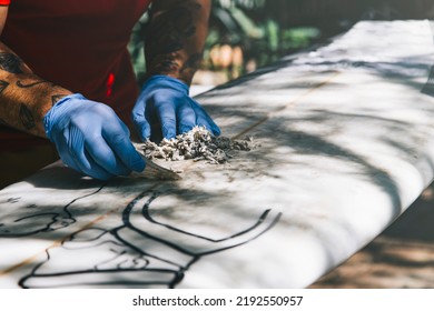 Surfer Cleaning His Surfboard. Remove Old Wax With A Wax Comb. Get Ready To Surf. Surfing Lifestyle.