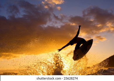 Surfer Does An Air At Sunset