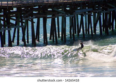 Surfer does a Cutback next to the San Clemente Pier