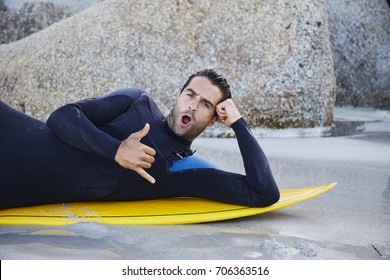 Surfer Dude In Wetsuit Gesturing On Board, Portrait