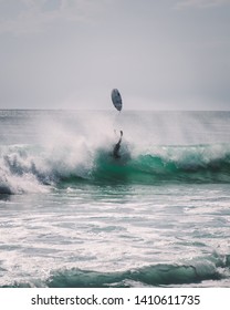 Surfer Falling Upside Down, Board In The Air. Surf Wipeout Fail