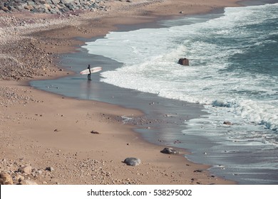 A Surfer Gazes Out Into The Surf Lineup And The Atlantic Ocean.