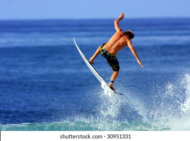 surfer gets air in Hawaii - Powered by Shutterstock