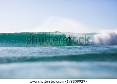 surfer getting barrelled at a beach in South Africa