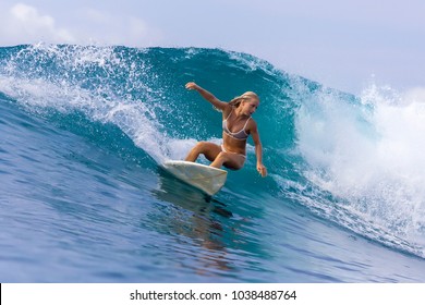 Surfer girl on a wave,Bali,Indonesia