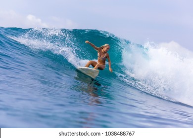 Surfer girl on a wave,Bali,Indonesia