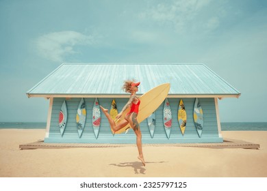 Surfer girl running with board on the sandy beach against surf station. Surfer female.Beautiful young woman at the beach. water sports. Healthy Active Lifestyle. Surfing. Summer Vacation.  - Powered by Shutterstock