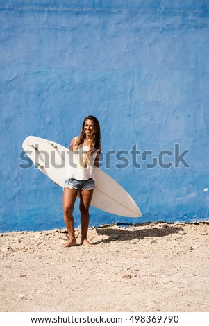 Similar – Surfer woman with bikini and wetsuit holding surfboard