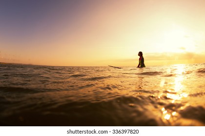 Surfer girl waiting for a wave